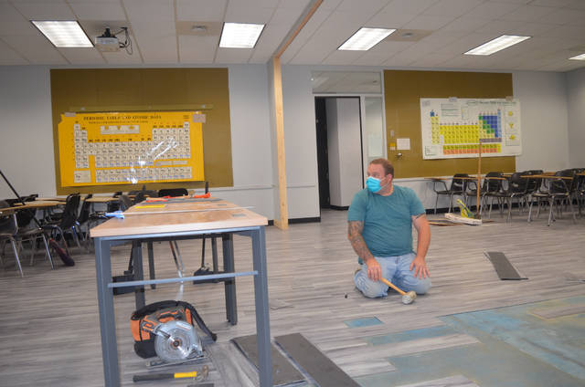125188310_web1_LCCC-1
Luzerne County Community College maintenance staff employee Ben Ulitchny waits for a piece of flooring to be cut to size to cover an area exposed when the wall between two classrooms was removed. The college is converting space to allow greater distance between students when they they return this fall after the COVID-19 pandemic closed schools statewide.
Mark Guydish | Times Leader