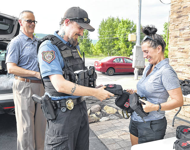 125241396_web1_WA-Kiwanis-Vest-Giveaway-1
Wyoming Area Kiwanis Invest in a Vest co-chairs Michael Coolbaugh, left, and Tiffany Callaio, right, hand over rifle-proof vests to Exeter Borough Patrolman Tyler Atherholt during pick up at Sabatinis Bottle Shop, Exeter, on June 23.
Tony Callaio | For Sunday Dispatch