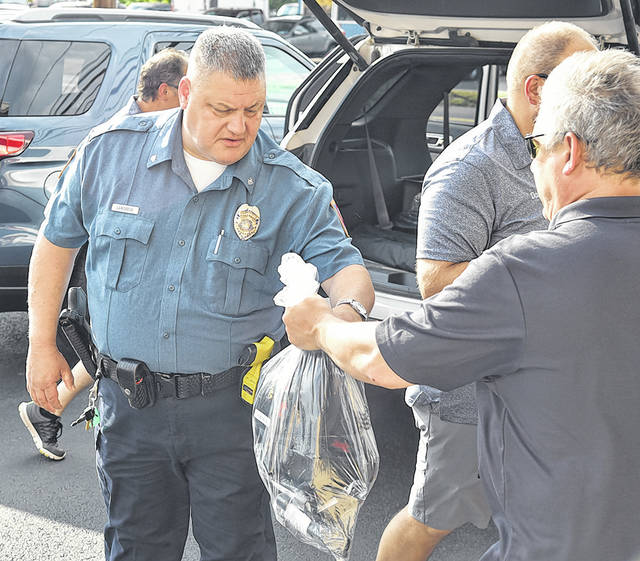 <p>Hughestown senior Patrolman Scott Lamoreux collects his first aid package from Kiwanian Bob Orlando.</p>
<p>Tony Callaio | For Sunday Dispatch</p>