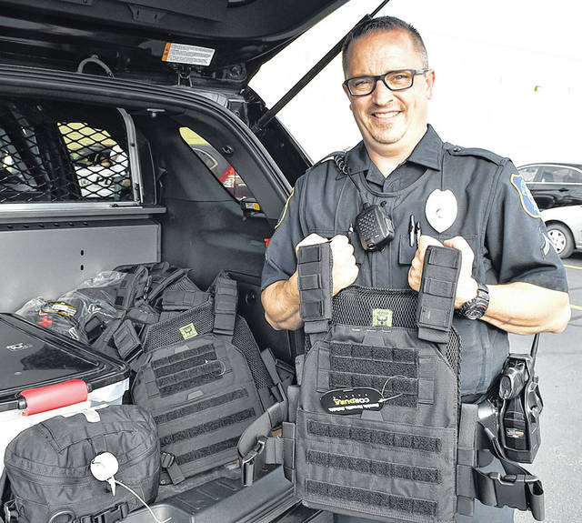 <p>City of Pittston Patrolman Dion Fernandez holds up one of 10 weighty rifle-proof vests donated by the Wyoming Area Kiwanis Club. Each vest costs $300.</p>
<p>Tony Callaio | For Sunday Dispatch</p>