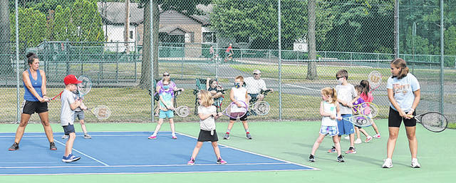 125463342_web1_GP-YMCA-Free-Tennis-Clinic-1
The Greater Pittston YMCA held a free tennis clinic at the Pittston Area Middle School courts on Aug. 3. Tennis instructor Tiffany Callaio, far left, with the aide of Pittston Area junior tennis player Kate Koss, far right, demonstrate the proper backhand technique to 5- to 7-year-olds during a free tennis clinic sponsored by the Greater Pittston YMCA and the United States Tennis Association.
Tony Callaio | For Sunday Dispatch