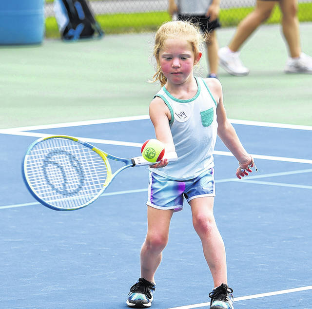<p>Five-year-old Ivy Cotter has her eye on the ball as she attempts to hit a forehand during the free YMCA tennis clinic.</p>
<p>Tony Callaio | For Sunday Dispatch</p>