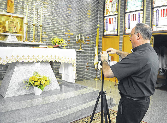 125497880_web1_Fr.-McDonnell-Oblates-1
Father Paul McDonnell prepares his cellphone to broadcast daily Mass live via Facebook at the chapel at the Oblates of St. Joseph Seminary, Laflin. Father Paul performs Mass each day at noon.
Tony Callaio | For Sunday Dispatch