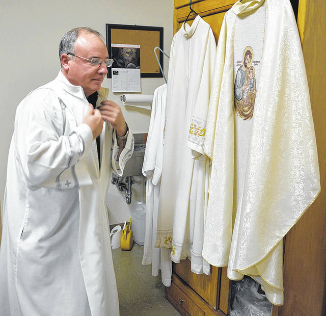 <p>Father Paul McDonnell, now in his 29th year as a Roman Catholic priest, prepares to hold Mass at the Oblates of St. Joseph Seminary last week.</p>
<p>Tony Callaio | For Sunday Dispatch</p>