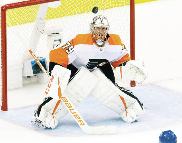 <p>Philadelphia Flyers goaltender Carter Hart watches the puck during first-period NHL Eastern Conference Stanley Cup first round playoff game against the Montreal Canadiens in Toronto on Friday.</p>