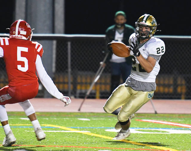 <p>Wyoming Area’s Leo Haros (22) breaks a few tackles before running behind Crestwood’s Marcus Vieney (5) for a 31-yard touchdown in the first quarter Friday night.</p>
<p>Tony Callaio | For Times Leader</p>
