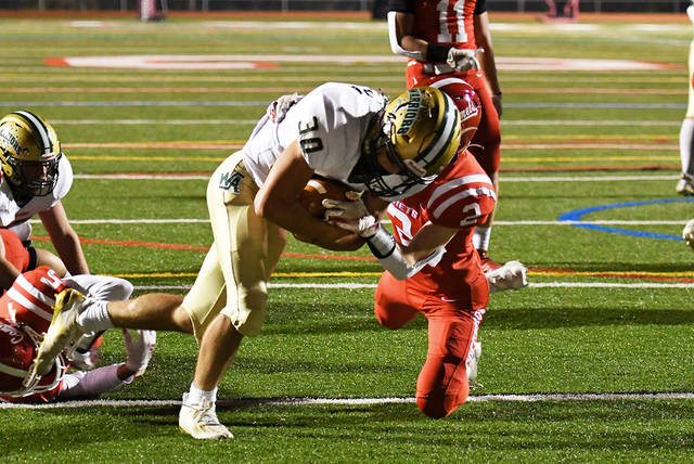 <p>Wyoming Area’s Vincenzo Giambra (30) bulls his way over Crestwood’s Julian McCure for a 6-yard touchdown late in the second quarter Friday night.</p>
<p>Tony Callaio | For Times Leader</p>