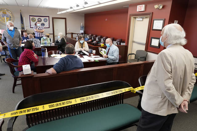 126048540_web1_126048540-e071a19d152e4346bae85c2ad6fed05d
In this Nov. 6 file photo an observer watches as Luzerne County workers canvas ballots that arrived after closing of voting but were postmarked by Nov. 3.
AP file photo
