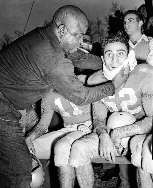 <p>Trainer Harry ‘Squab’ Jones, left, applies the towel to Georgia’s Charley Trippi after the Bulldog Star ran 66 yards to score the last touchdown against Georgia Tech in Athens, Ga. on Nov. 30, 1946. Trippi led the Bulldogs to a spot in the Sugar Bowl.</p>
<p>AP file photo</p>