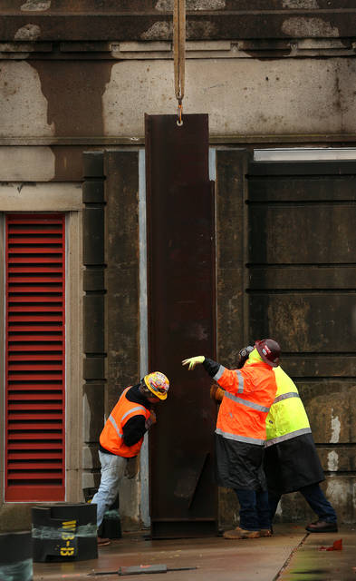 <p>A crew of workers set the first rib of the floodgates on the Market Street Bridge along River Street in Wilkes-Barre on Christmas morning.</p>
<p>Fred Adams | For Times Leader</p>