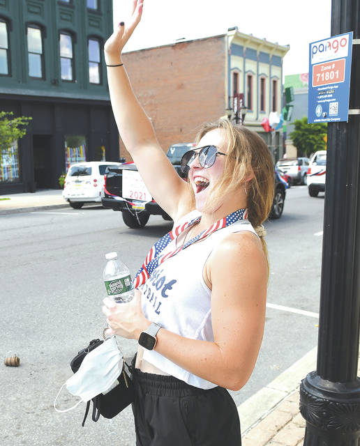 <p>Tiara George waves to the dozens of cars passing by her sports banner on Sunday, June 6. George’s banner was one of nearly 80 banners hanging on Main Street, Pittston, honoring senior athletes, band members, cheer squad members and class officers.</p>
<p>Tony Callaio | For Sunday Dispatch</p>