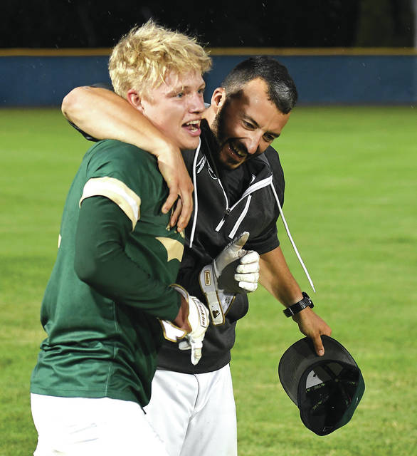 <p>Warrior head coach Rob Lemoncelli embraces Evan Melberger at the conclusion of the PIAA state semi-final game victory.</p>
<p>Tony Callaio | For Times Leader</p>