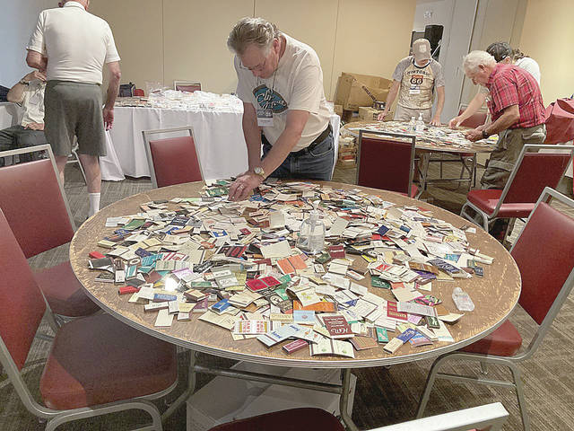 <p>Missouri native Steve Moldovan browses one of the ‘freebie’ tables, where a variety of matchbooks are available for collectors.</p>
<p>Kevin Carroll | Times Leader</p>