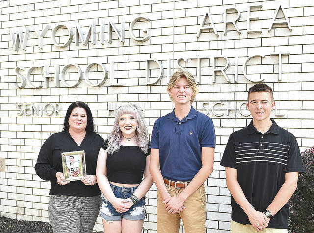 127482183_web1_Busch-Scholarship-4-copy
Amy Callahan, mother of the late Jake Busch, holds a photo of her son while standing with the first-ever recipients of the Jacob Jake Busch Memorial Scholarship. From left are Callahan, Krya Britzke, Joseph JT Gober and Michalene Flynn.
Tony Callaio | For Sunday Dispatch