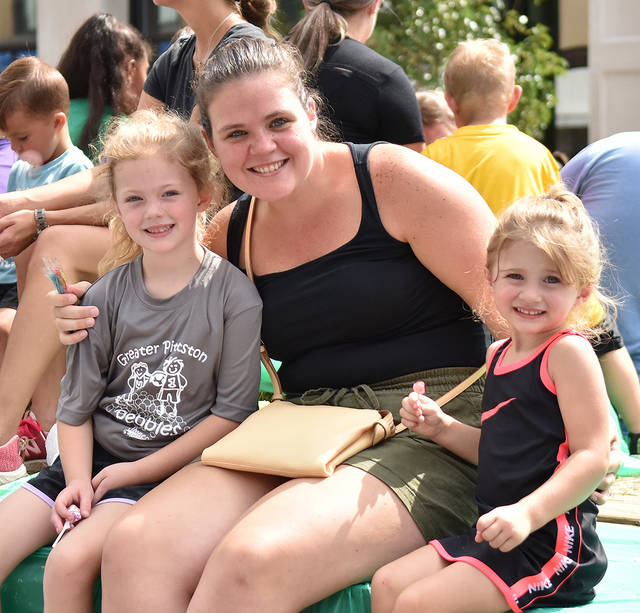 <p>Linda Terran and her two children, Addison, 5, left, and Nora, 3, ride on the Pittston Stoners float in Saturday’s parade.</p>
<p>Tony Callaio | For Sunday Dispatch</p>