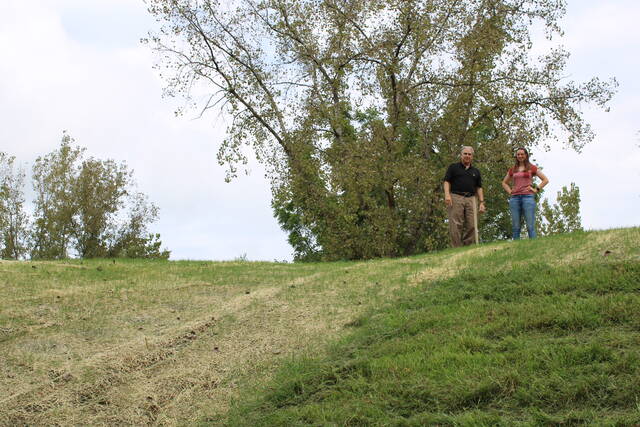 <p>Christopher Belleman and Michaela Fehn look down from a now-closed Wyoming Valley Levee system section that had been open for trains that once passed through near Swetland Lane in Wyoming. Belleman is executive director of the Luzerne County Flood Protection Authority, while Fehn is the authority’s project engineer.</p>
<p>Jennifer Learn-Andes |Times Leader</p>