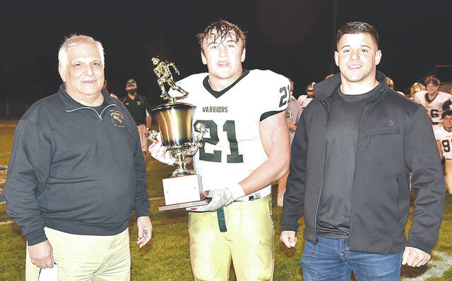 <p>Wyoming Area Warrior sophomore Drew Mruk captured the Carmello Falcone game MVP trophy in 2020. Standing with Mruk is Carmello’s son, Carmen Falcone, left, and grandson, Sam Falcone.</p>
<p>Tony Callaio file photo</p>