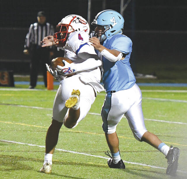 <p>Robby Barbieri (4-white) hauls in a pass for extra yardage with Jake Delguadio (4-blue) defending.</p>
<p>Tony Callaio | For Times Leader </p>