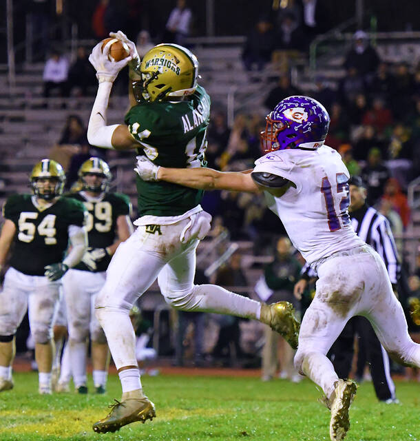 <p>Wyoming Area’s Usamah Alansari (14) escapes a tackle attempt by Lakeland’s Jon Seamans on his way to a 51-yard touchdown reception at 7:01 of the third quarter Friday night.</p>
<p>Tony Callaio | For Times Leader</p>