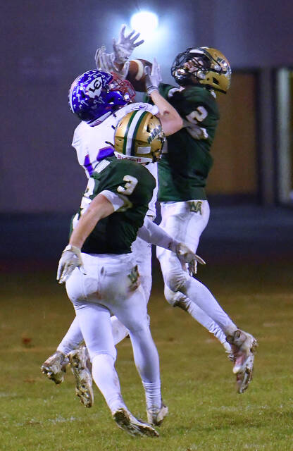 <p>Wyoming Area’s John Morgan (2) intercepts a pass intended for Lakeland’s Jon Seamans in the fourth quarter as Rocco Pizano (3) also defends.</p>
<p>Tony Callaio | For Times Leader</p>