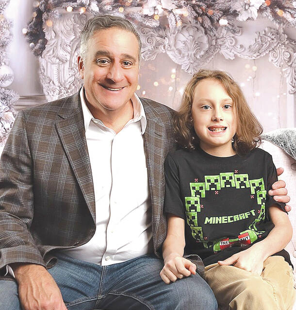 <p>Pittston City Mayor Michael Lombardo sits beside the city’s 2021 Christmas Ambassador, 10-year-old Theo Niedzwiecki. Theo, a fifth-grade student at Pittston Area, will light the city’s Christmas tree at 6 p.m. on Saturday, Dec. 4, at the Pittston Tomato Festival lot on Main Street. </p>
<p>Photo courtesy of MPK Photography</p>