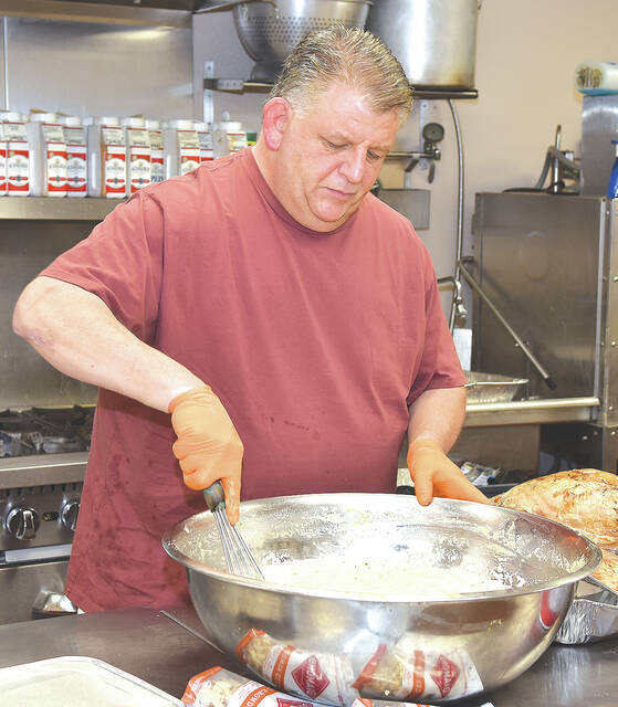 <p>Pictured is Chef Dante LaFratte busy prepping food in the kitchen at the Pittston Meals on Wheels. The organization delivered 70 Thanksgiving dinners Thursday morning.</p>
<p>Tony Callaio | For Sunday Dispatch</p>