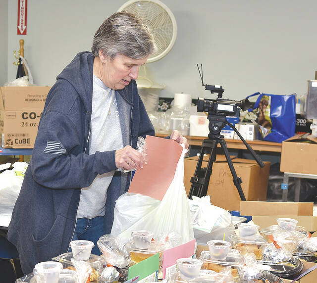 <p>Pictured is Lois McHugh, Pittston Meals on Wheels director, busy filling out Thanksgiving day meals to be delivered by area law enforcement officers.</p>
<p>Tony Callaio | For Sunday Dispatch</p>