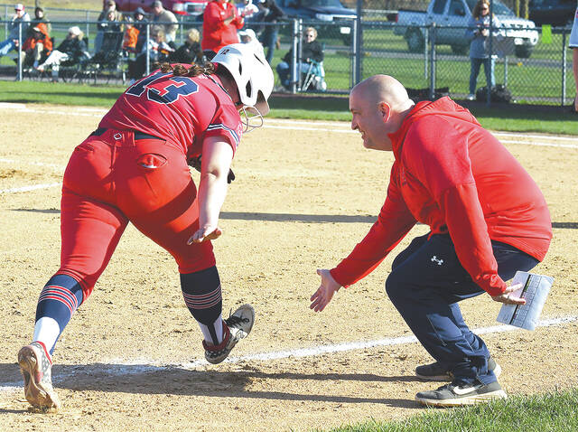 <p>Pittston Area third base coach Mike Callahan gives a low-five to starting pitcher Tori Para as she drilled a solo home run in helping her cause.</p>
<p>Tony Callaio | For Sunday Dispatch</p>