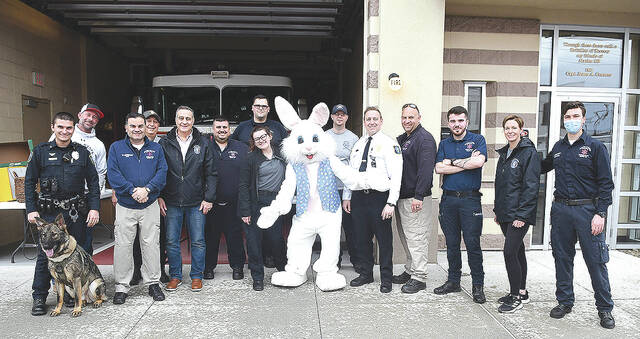 <p>The Easter Bunny, City of Pittsotn firefighters, EMT’s, Mayor Michael Lombardo, Main Street manager Mary Kroptavich, along with K-9 Fritz took part in the annual Easter chocolate giveaway.</p>
<p>Tony Callaio | For Sunday Dispatch</p>