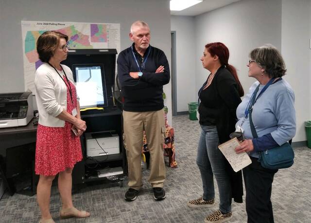 128523173_web1_elect1
Four of Luzerne Countys five Election Board members chat in the county election bureau after the polls closed Tuesday night. From left are: Denise Williams, James F. Mangan Jr., Alyssa Fusaro and Audrey Serniak.
Jennifer Learn-Andes | Times Leader