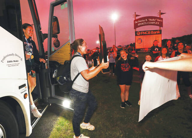 <p>Outfielder Sage Weidlich was the first off the bus with the state trophy at Pittston Area Primary Center in Hughestown, as a crowd awaited to celebrate the Patriots’ title on Thursday night.</p>
<p>Fred Adams | For Sunday Dispatch</p>