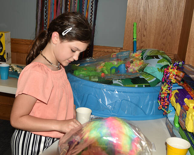 <p>Ten-year-old Francesca Prato carefully places a raffle ticket into a cup during Pittston’s Day Downtown.</p>
<p>Tony Callaio | For Sunday Dispatch</p>