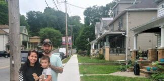
			
				                                Ian and Victoria Bennett, holding Ian Jr., stand near their house on new sidewalks Newport Township has installed along one-mile West Main Street in the Glen Lyon section.
                                 Jennifer Learn-Andes | Times Leader

			
		