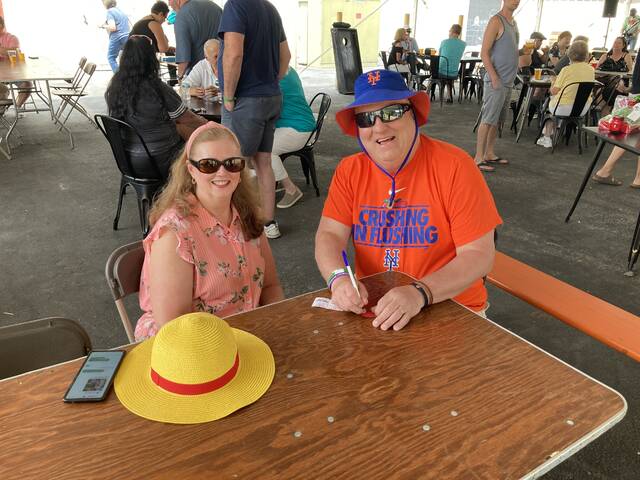 <p>Mary Beth and David Morris pose for a photo after buying some raffle tickets at Sunday’s Greater Pittston Santa Squad Christmas in July fundraiser at the Susquehanna Brewing Co. in Pittston.</p>
<p>Kevin Carroll | Sunday Dispatch</p>