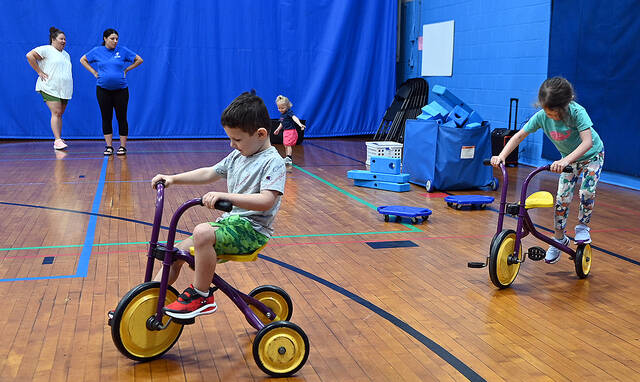 128747498_web1_GP-YMCA-Mommy-Soccer-1
Kendal, Greater Pittston YMCA, back right, chats with participating mom Christine Wine, Kingston. Joseph Carmody, 4, front center, and Caroline Carmody, 5, right, ride bicycles and two-year-old Olivia Wine, back center, was busy kicking a ball around the gym of the YMCA on Wednesday, July 27 for Mommy and Me soccer play.
Tony Callaio | For Sunday Dispatch