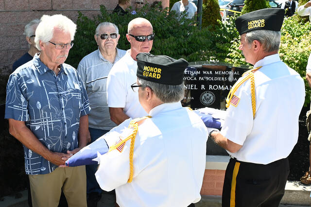 <p>The Honor Guard members of AmVets Post 189 preent the U.S. Flag to Pat Clifford, back left, on behalf of his late brother Michael Clifford, and to Rick Romanko, back center, brother of the late Daniel Romanko, after losing their lives in Vietnam in the 1960s.</p>
<p>Tony Callaio | For Sunday Dispatch</p>