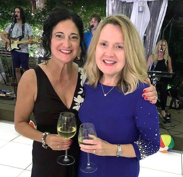 <p>One of Lori Nocito’s dearest friends, Patty Klein, shares a moment at Nocito’s retirement party.</p>
<p>Tony Callaio | For Sunday Dispatch</p>