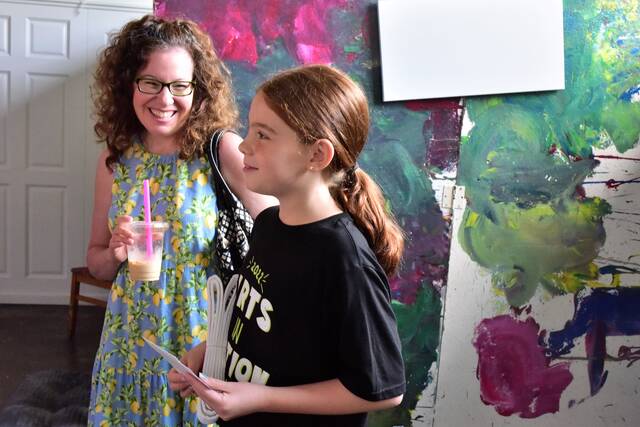 <p>Joy Tetlak of Dupont, at left, listens to her daughter, 11-year-old Mia Adelstein, talk about the dancing, painting and other activities she enjoyed during the summer art camp held at the ANNAMALY Gallery.</p>
<p>Mark Guydish | Times Leader</p>