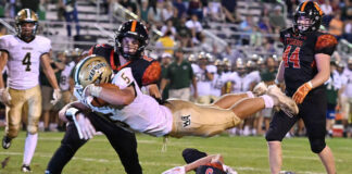 
			
				                                Wyoming Area Aaron Crossley leaps over the the last two Tunkhannock defenders for one of his four rushing downs Friday night.
                                 Tony Callaio | For Times Leader 

			
		