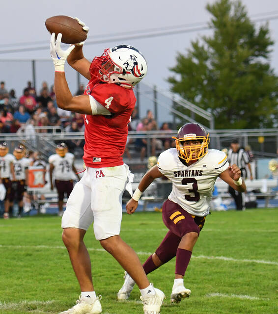 <p>Junior Robby Barbieri (4) hauls in a pass in the flat as Wyoming Valley West defender Erick Munoz (3) moves in for the tackle.</p>
<p>Tony Callaio | For Times Leader</p>