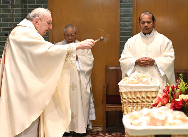 <p>Fr. Joseph Sibliano, O.S.J., left, blesses baskets of bread to be passed out to the congregation at the Oblates of St. Joseph Seminary Chapel on Labor Day honoring St. Joseph the Worker. Fr. Raymond Tabon, O.S.J., back center, and Fr. Jackson Pinheiro, O.S.J., back right, look on.</p>
<p>Tony Callaio | For Sunday Dispatch</p>