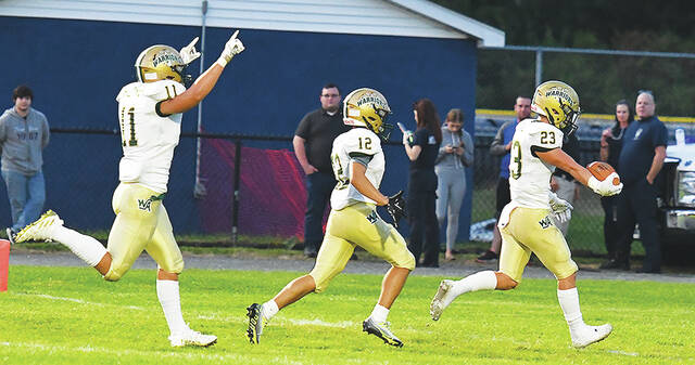 <p>Warrior sophomore Michael Crane (23) recovered a fumble for a Wyoming Area score. Teammates Gage Speece (12) and James Hizynski (12) follow.</p>
<p>Tony Callaio | For Sunday Dispatch</p>