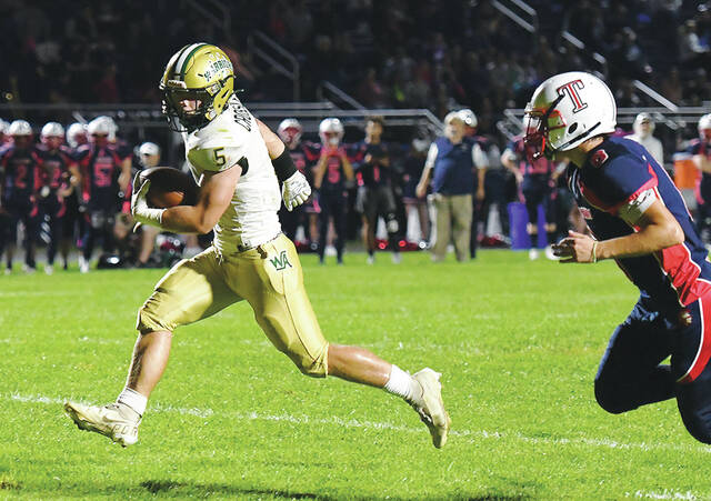 <p>Aaron Crossley (5) broke several Trojan tackles before scoring a Warrior touchdown. Nanticoke Area’s Ayden Kolet (8) was in pursuit.</p>
<p>Tony Callaio | For Sunday Dispatch</p>