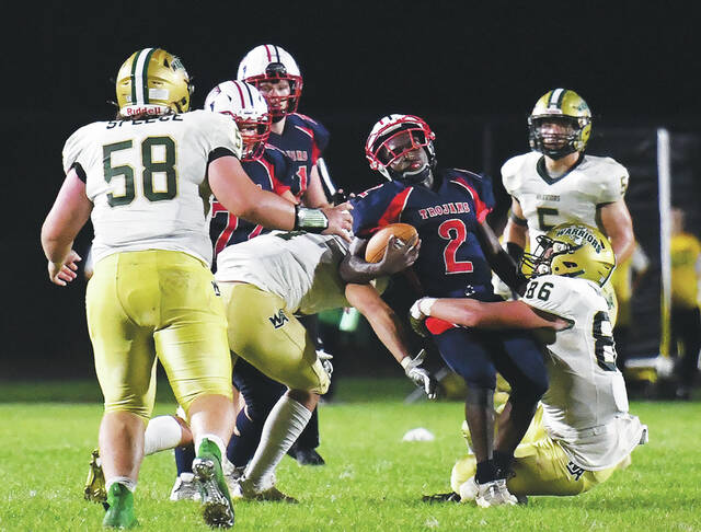 128899425_web1_WA-Nanticoke-ftbl-6
Wyoming Areas James Hizynski (11) and senior tackle Riley Knaub (86) tackle the Trojans Jaylin Collins (2) in the closing minutes of the first half.
Tony Callaio | For Sunday Dispatch