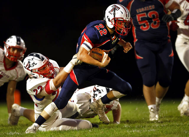 <p>Nanticoke Area running back Zach Fox (22) tries to break free from Pittston Area linebacker Drew Menendez (22) early in the first quarter on Friday.</p>
<p>Fred Adams | For Times Leader</p>
