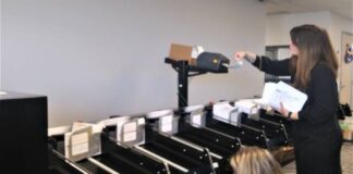 
			
				                                Luzerne County Administrative Services Division Head Jennifer Pecora, at left, and Acting Election Director Beth McBride retrieve mail ballots in the county election bureau Friday during a demonstration of a new ballot sorting machine.
                                 Jennifer Learn-Andes | Times Leader

			
		