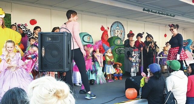 <p>Mary Kroptavich, front left, and Sarah Donahue, front right, organize groups for the Halloween costume contests.</p>
<p>Tony Callaio | For Sunday Dispatch</p>