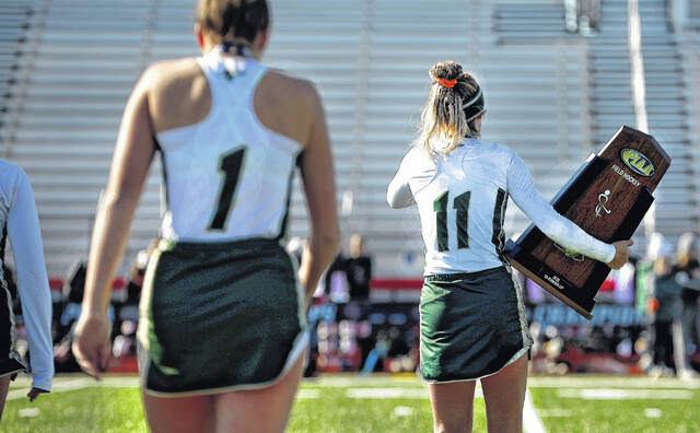 <p>Wyoming Area’s Alexys Moore carries the runner-up trophy back to the team bench.</p>
<p>Fred Adams | For Sunday Dispatch</p>