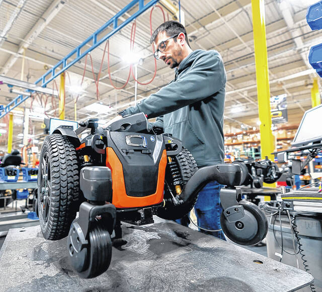 <p>Pride Mobility Manufacturing Engineer technician Jamie LaNunziata assembles a custom ordered an all battery-powered scooter.</p>
<p>Tony Callaio | For Sunday Dispatch</p>