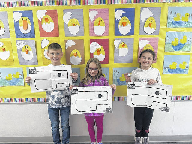 <p>Austin Bartush, Emma Bratlee and Ellie Schuh proudly display their Ozobot coded path to the pond.</p>